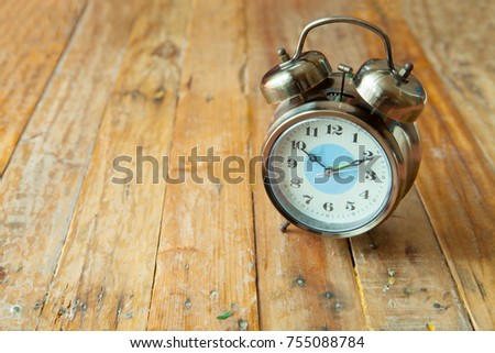 Big vintage alarm clock with bells, painted antique wooden background