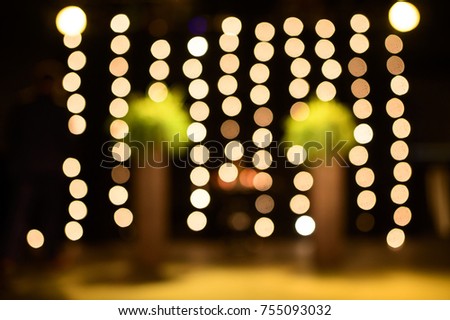 Strings of lights create a bokeh vision at a venue.
