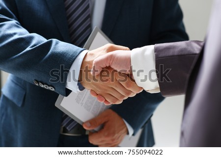 Man in suit shake hand as hello in office closeup. Friend welcome mediation offer positive introduction greet or thanks gesture summit participate approval background strike arm bargain concept Royalty-Free Stock Photo #755094022