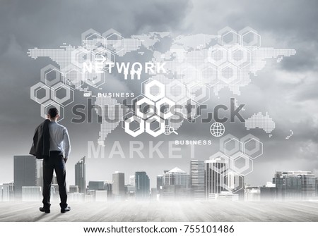 Back view of young businessman on city background with business icons and chart