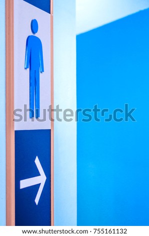 Blue sign at the entrance of the men's bathroom.