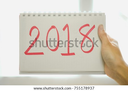 happy new year background hand of young woman hold paper with message new year 2018 inside. image for festival, holiday, body, person, international, idea concept