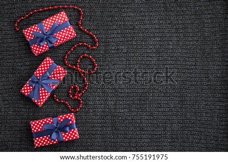 Christmas background with gift boxes on knitted background
