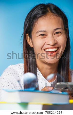 woman sitting smiling with fun and happy on the desk.woman happy after working.