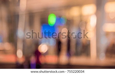Abstract blur People walking at shopping mall on night time  with bokeh for background usage . (vintage tone)