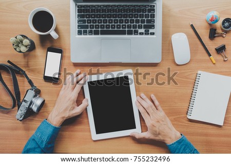Businessman hand using tablet,laptop, online banking payment communication network.Top view