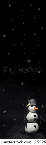 Black Friday abstract photo. Happy Merry Christmas. Snowman made from plasticine on black background.