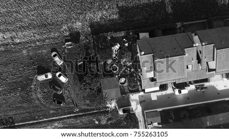 Children playing outdoor in a house garden, overhead view.