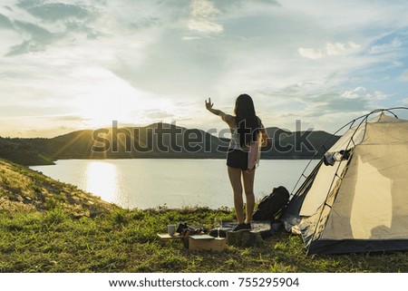 Happy young woman make hand sign i love you and enjoy view of magnificent landscape while tenting on vacation.