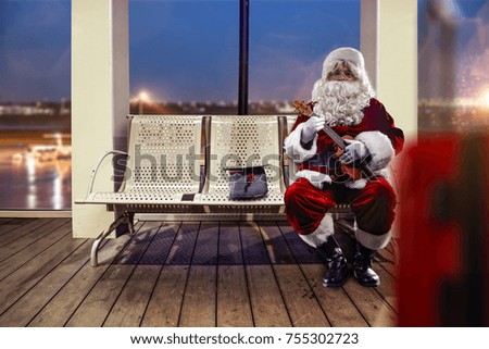Santa Claus on airport. Background with big window and dark blue sky. 