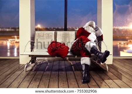 Santa Claus on airport. Background with big window and dark blue sky. 