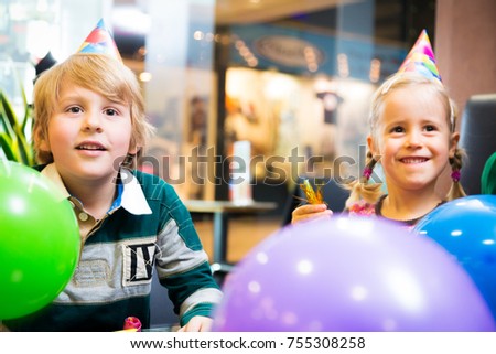 mother and her children having a birthday party at a cafe