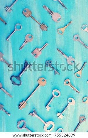 background from various keys on a blue wooden background - top view of the keys
