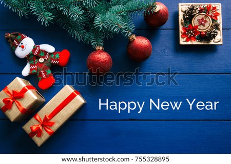 New year's background on a purple desk decorated with toys, presents, Santa Claus, snowman. Bright colored background symbolizes the new year celebration. Great useful template to wright words down.