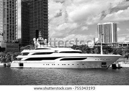 Downtown Miami along Biscayne Bay with condos and office buildings, yacht docked in the bay