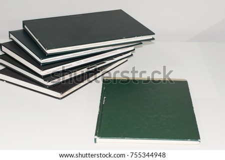 Stack of books, meeting reporting on white table, business and education concept.