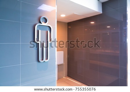 modern public men toilet sign on granite wall tile at the entrance