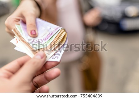 Corruption concept, man taking money from woman. Paying - hand giving euro banknotes to another hand. Money Loan. business woman and a businessman hold money. Human hands exchanging money.