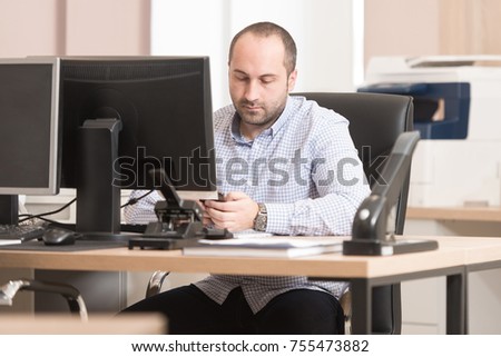 Young Handsome Businessman Working With Computer At Desk In The Modern Office Talking On Phone