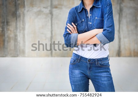 Closeup woman casual outfits standing cross one's arm and wear jeans denims