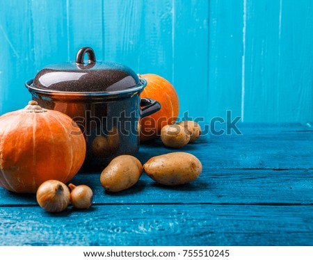 Picture of iron pot with lid, vegetables, potatoes, pumpkin, onions