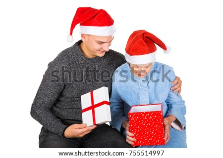 Picture of an old lady receiving Christmas gifts from her grandson