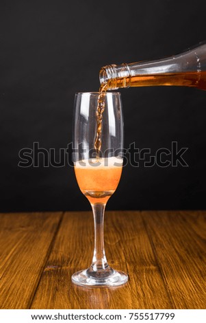 red champagne glass on a wooden background