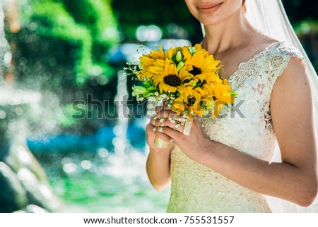 Wedding yellow bouquet in the hand of the bride