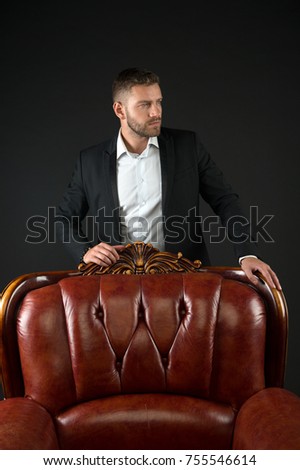 Manager with beard on confident face in office. Business and success. Modern life and agile business. Man in formal outfit at leather chair on black background. Businessman or ceo fashion.