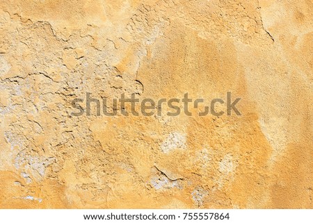 Uneven yellow wall surface texture detail background