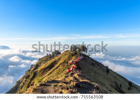Camping site on crater rim of Mount Rinjani at sunset. Lombok Island, Indonesia. Royalty-Free Stock Photo #755563108