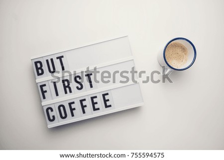 But First Coffee displayed on a vintage lightbox with coffee cup, concept image