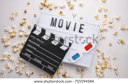 Lightbox with words "Movie" and clapper board with 3D glasses, concept image