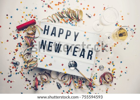 Happy New year displayed on a vintage lightbox with decoration for New Year's Eve, concept image Royalty-Free Stock Photo #755594593