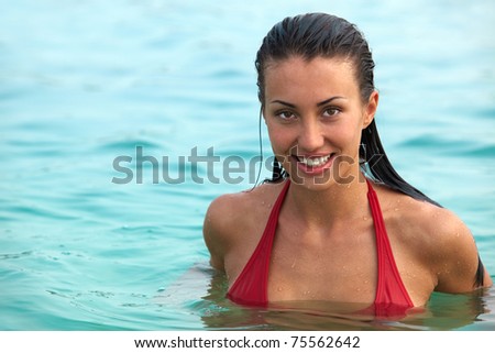 Portrait of wet attractive woman in water