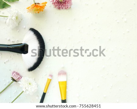 Eye shadow brush and makeup brush on white background decorate with flower in natural and beauty style