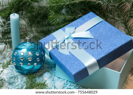 Gift box and blue xmas ball with christmas tree