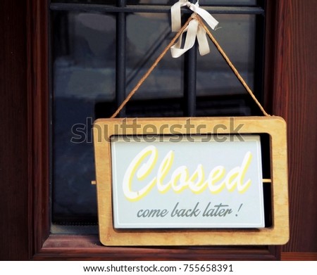 We are closed, come back later. Retro sign on the door of a shop.