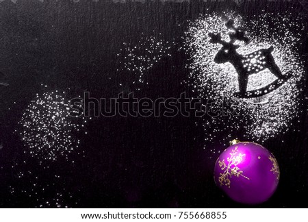 Christmas picture with deer on the snow and decoration purple toy