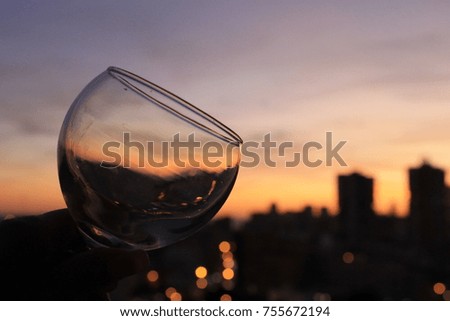 We observe in romantic sunset through the glass cup. Enigmatic sunset in shades of yellow, orange and fire red.