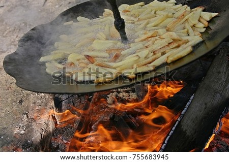 Process of preparation of potato on an open fire on a frying pan