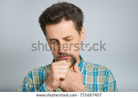 Handsome middle-aged man coughs, wearing glasses, isolated on background