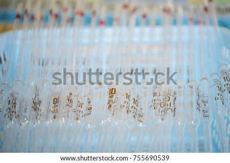 volumetric pipette stacked on a basket. Close up image
