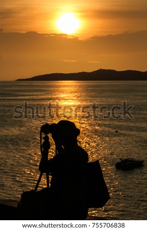 Tourists are shooting sunset.