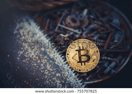 Gold bitcoin. crypto currency bitcoin against a background of rusty tools a simple working consumer. problems and business growth. warm toning.