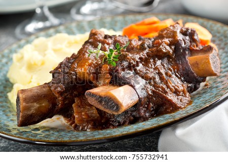 Delicious braised beef ribs with mashed potato and carrots. Royalty-Free Stock Photo #755732941