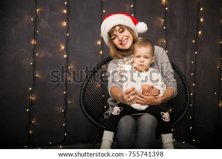 Mother and daughter sitting in a chair on Christmas