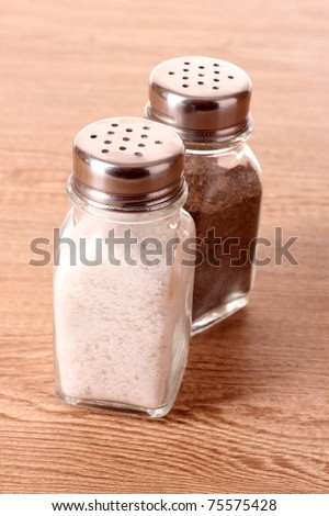 Salt and pepper shaker on wooden background