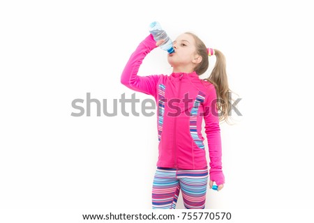 Girl drink water from bottle. Fluid balance, hydration. Child feel thirsty in pink suit isolated on white. Health and healthy drinking. Dehydration, thirst concept, copy space