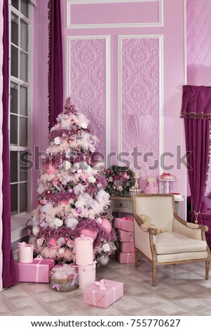 Christmas tree on new year's Eve in a white room with  gifts. Gifts under the Christmas tree.  Christmas tree decorated in pink